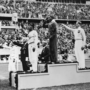 the gold, silver and bronze medal winners in the long jump competition salute from the victory stand at the 1936 summer olympics in berlin from left, japans naoto tajima bronze, american jesse owens gold who set an olympic record in the event and offers an american style salute with his hand to his forehead, and germanys luz long silver giving a nazi salute with his arm extended out august 8, 1936