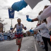 volunteers hand out water at the new york city marathon