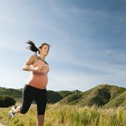 pregnant hispanic woman running in remote area
