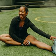 a runner stretching on the field